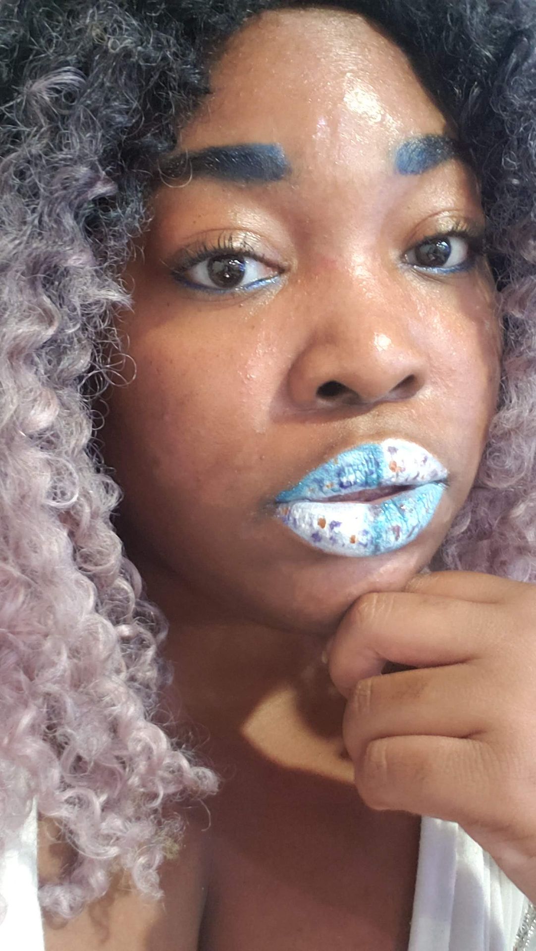 Black woman with silver curls and icy blue crystal lip art