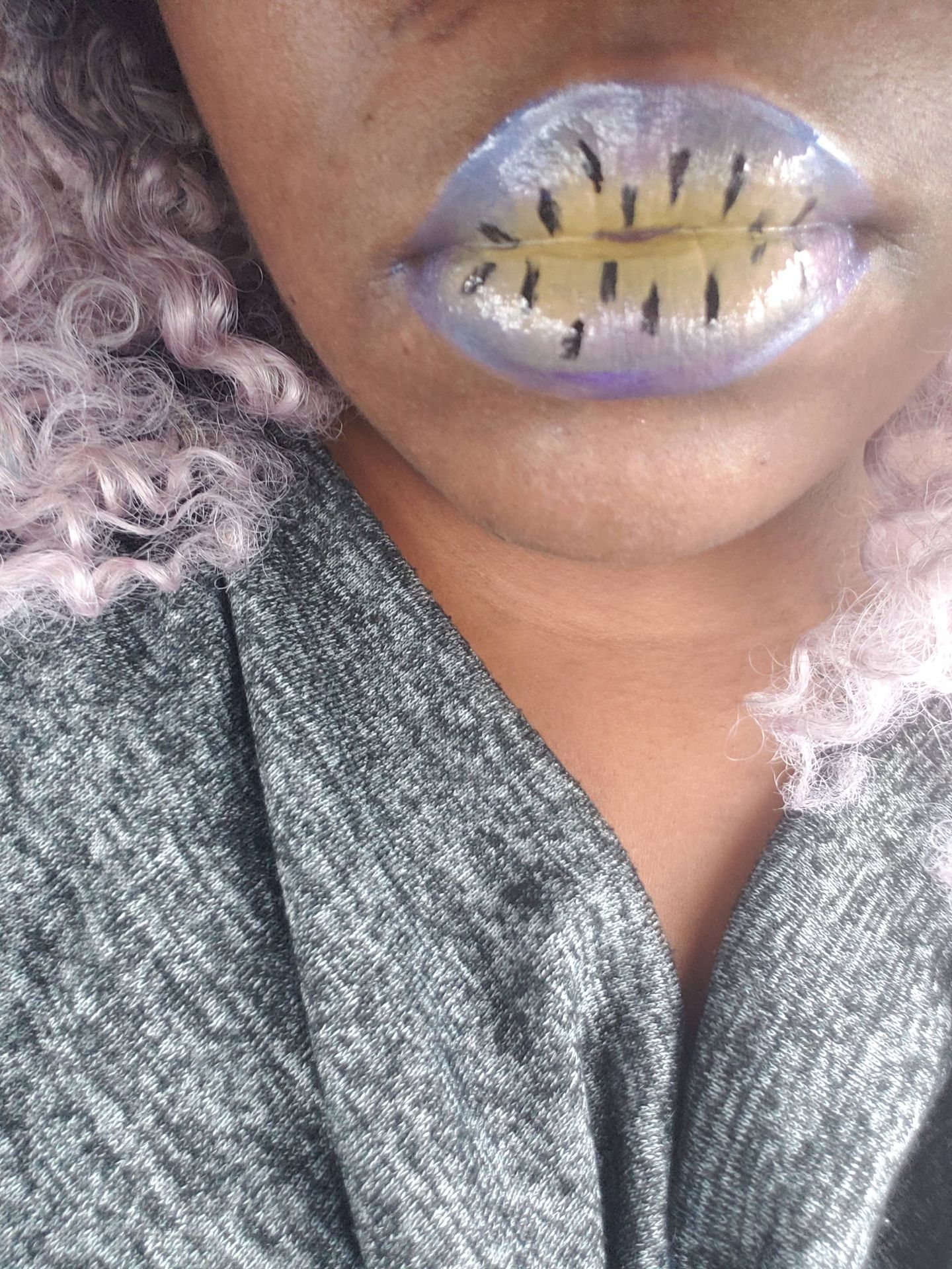 Close-up of gold foil texture layered over nude lips