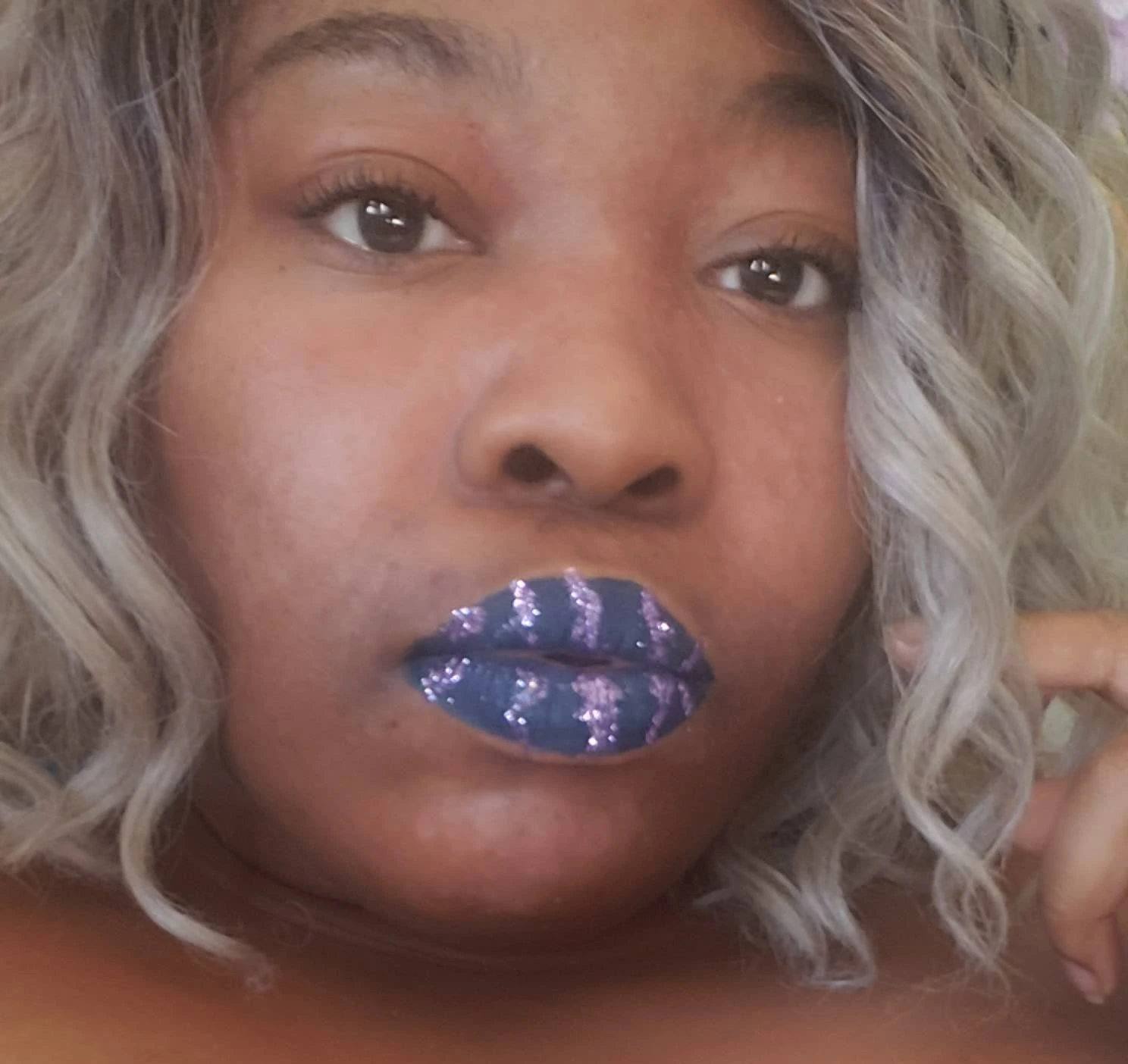 Close-up of lips with purple and blue crystal mosaic design