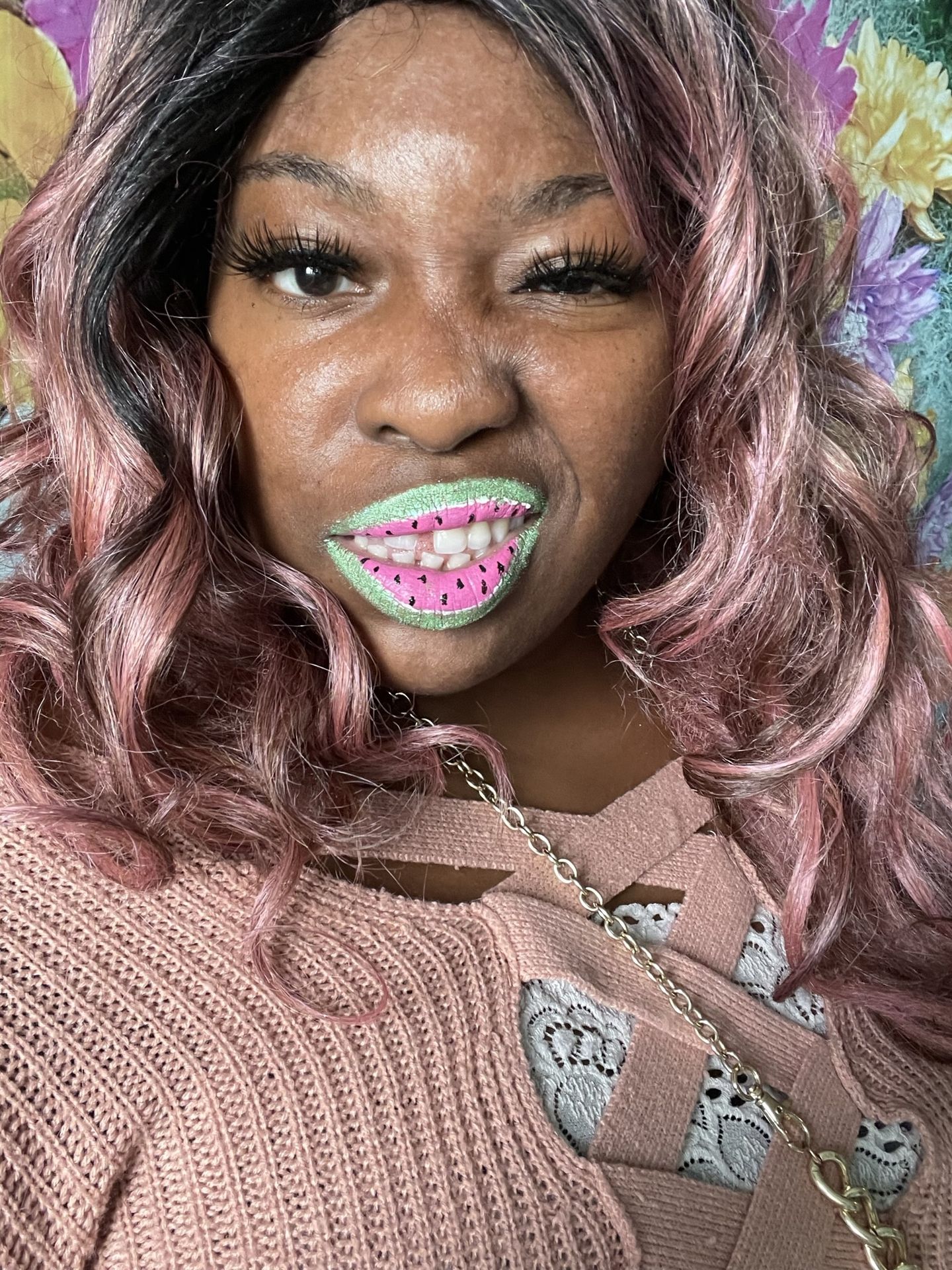 Black woman with silver-gray curls and holographic glitter lipstick