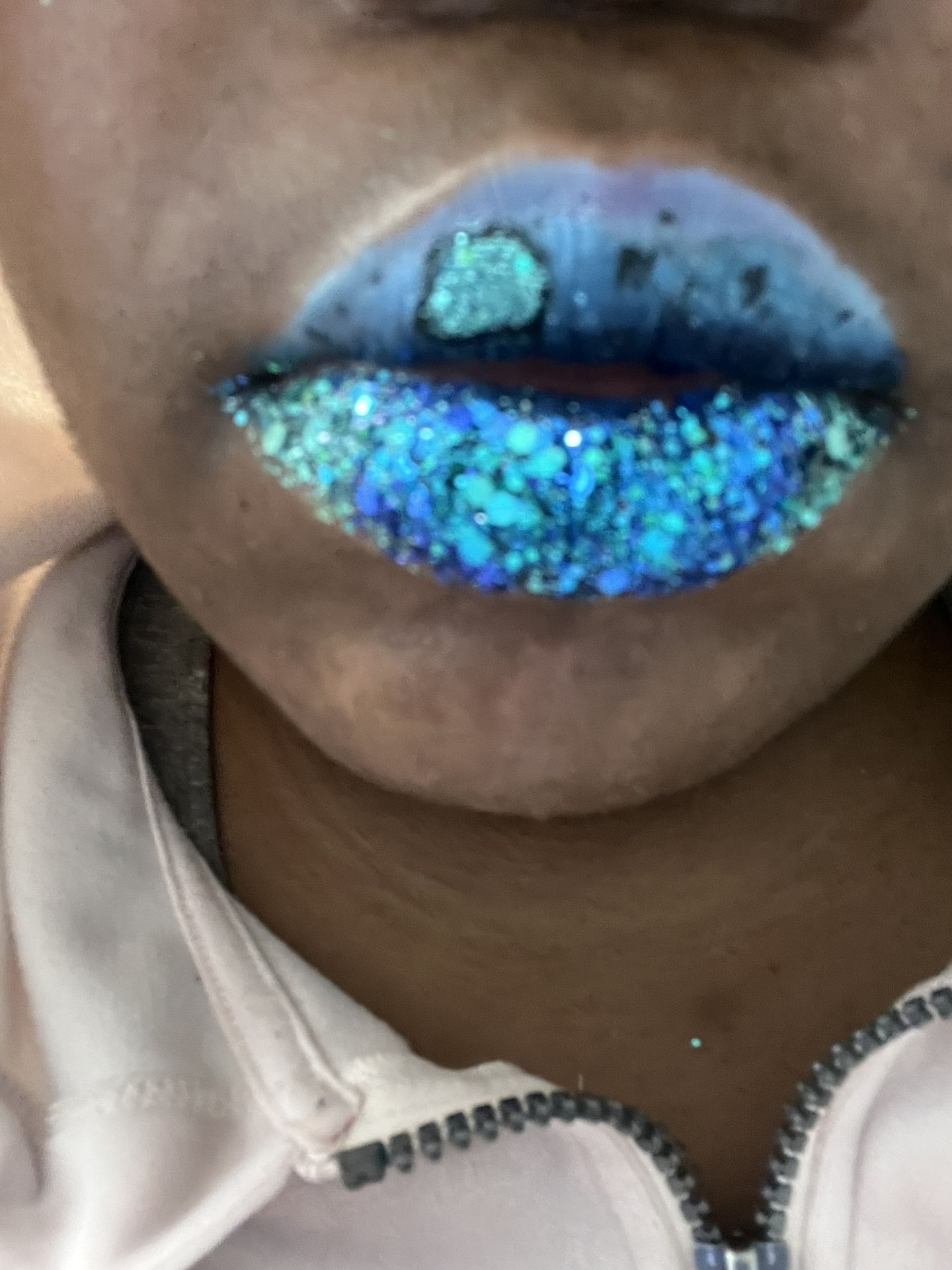 Close-up of metallic ocean-blue chrome lipstick