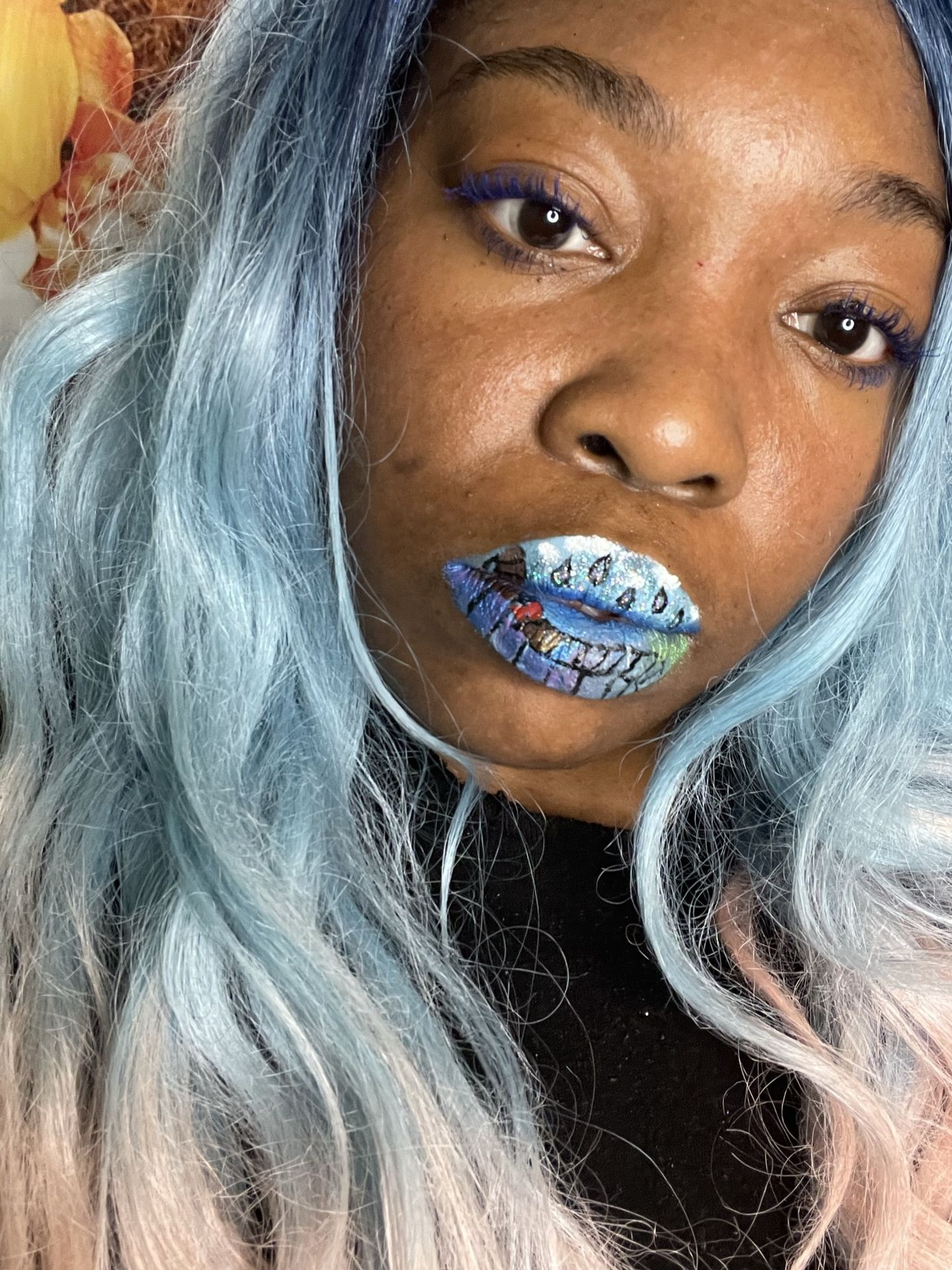 Woman with silver-blue hair wearing deep teal crystal-studded lipstick