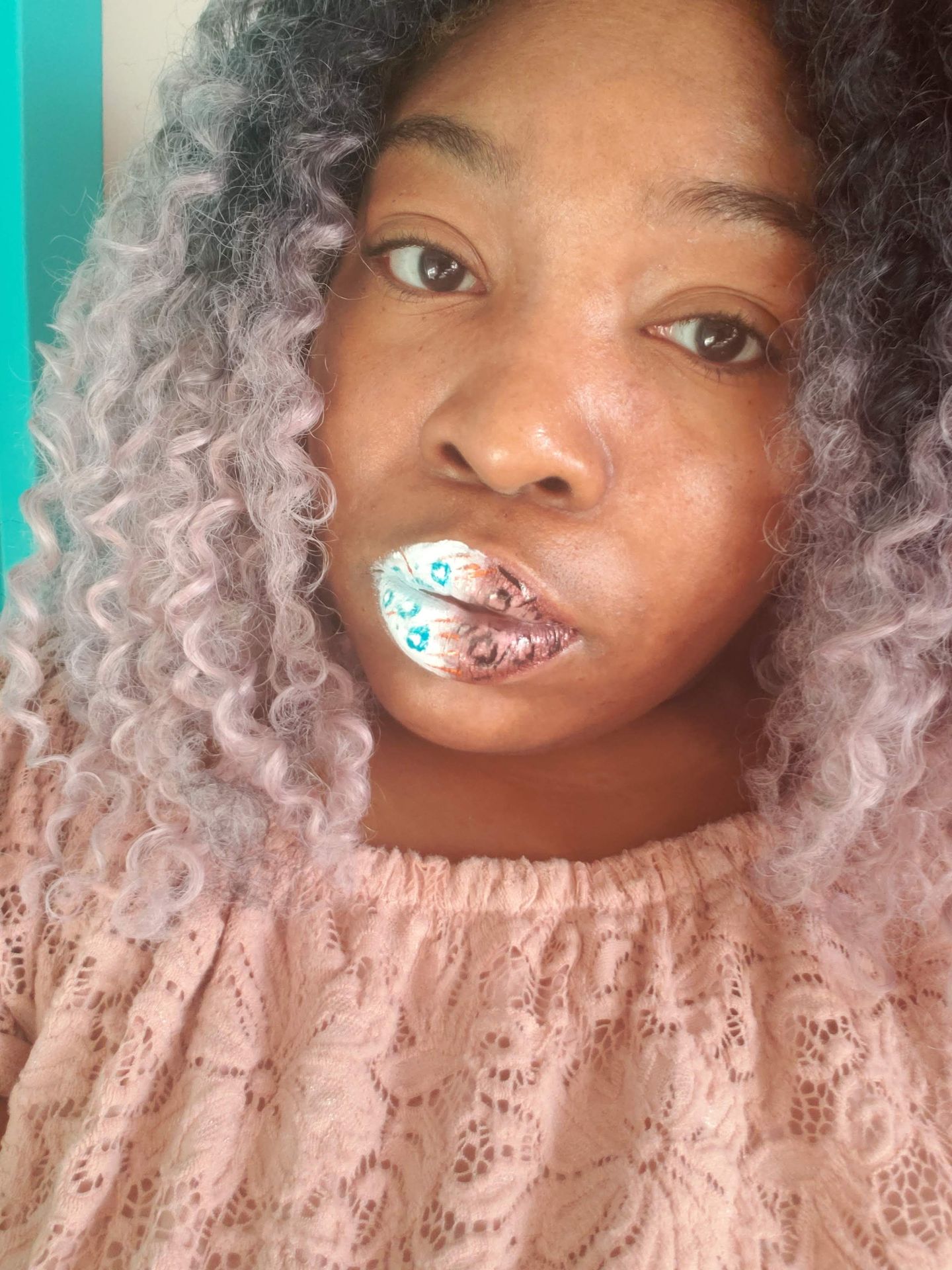 Black woman with natural curls and rainbow crystal lip design, expressive beauty photography with vibrant color.