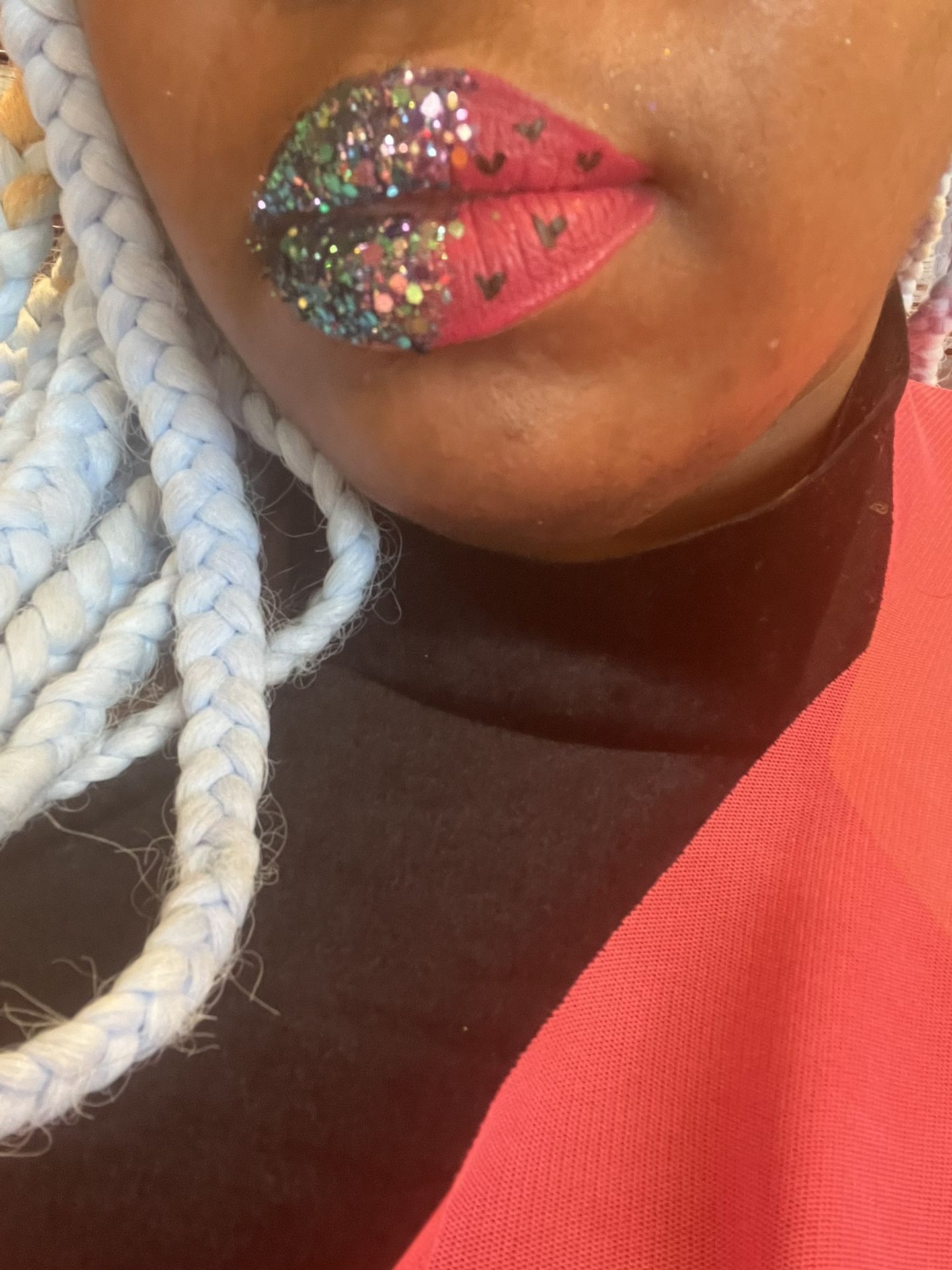 Close-up of multicolored rhinestone lips with white braids