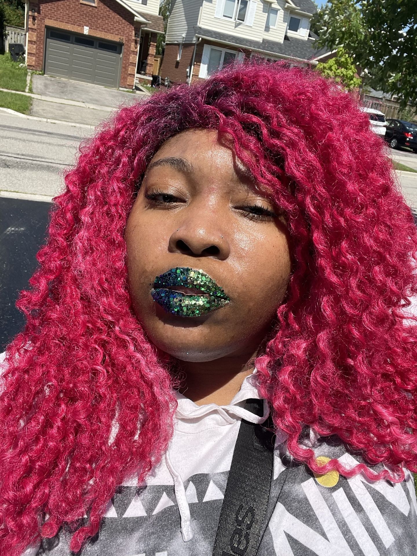 Woman with hot pink curls and metallic jade lipstick