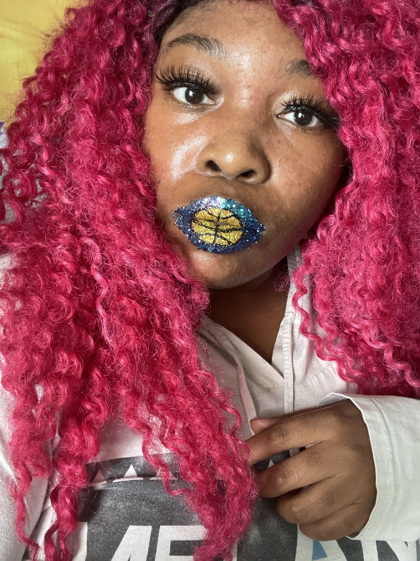 Woman with crimson curls wearing gold and navy mosaic lip art
