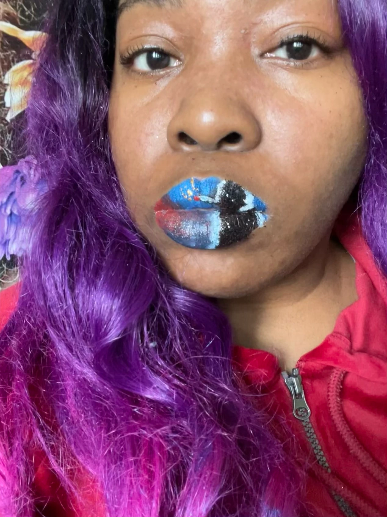Woman with purple curls wearing ocean-blue rhinestone lip pattern