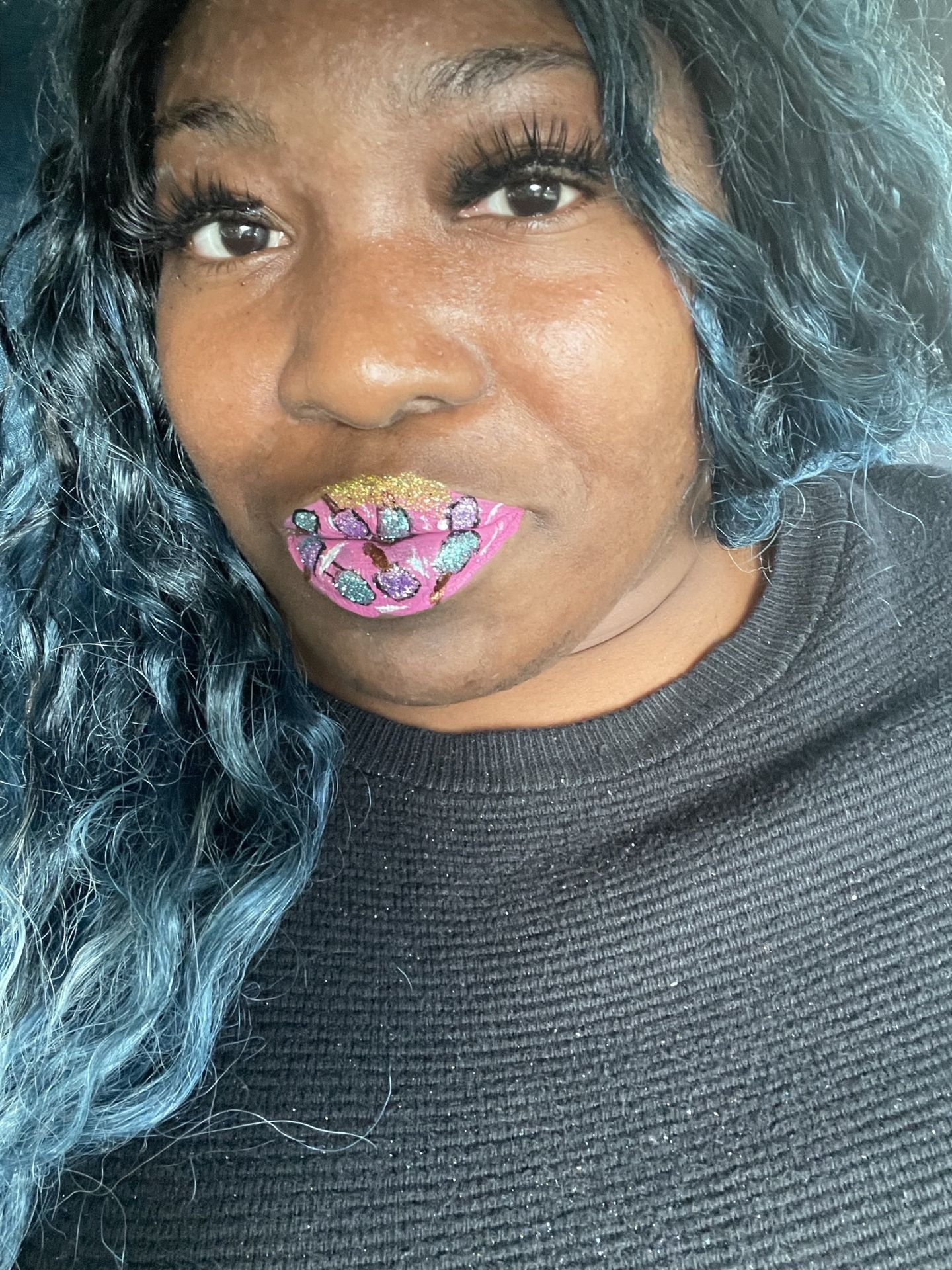 Black woman with dark hair and rainbow chrome lip finish