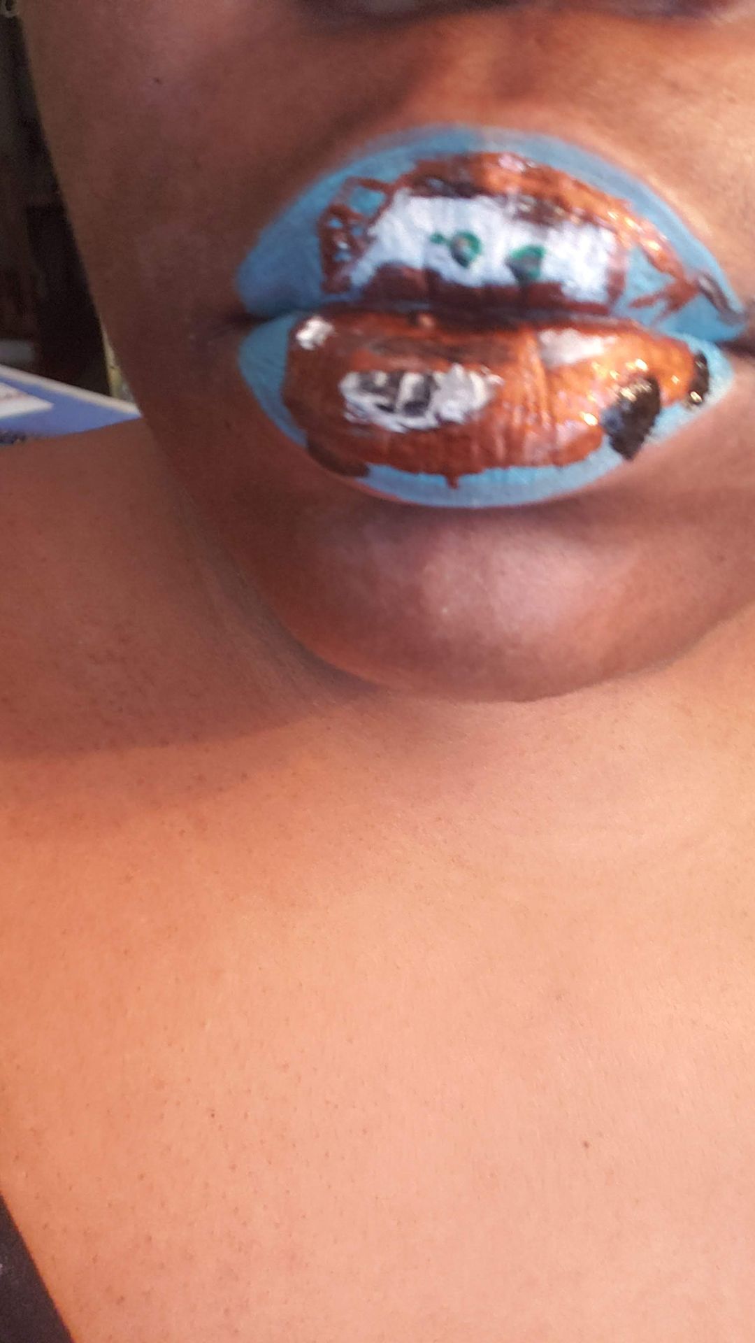 Close-up of copper and silver mosaic lip art