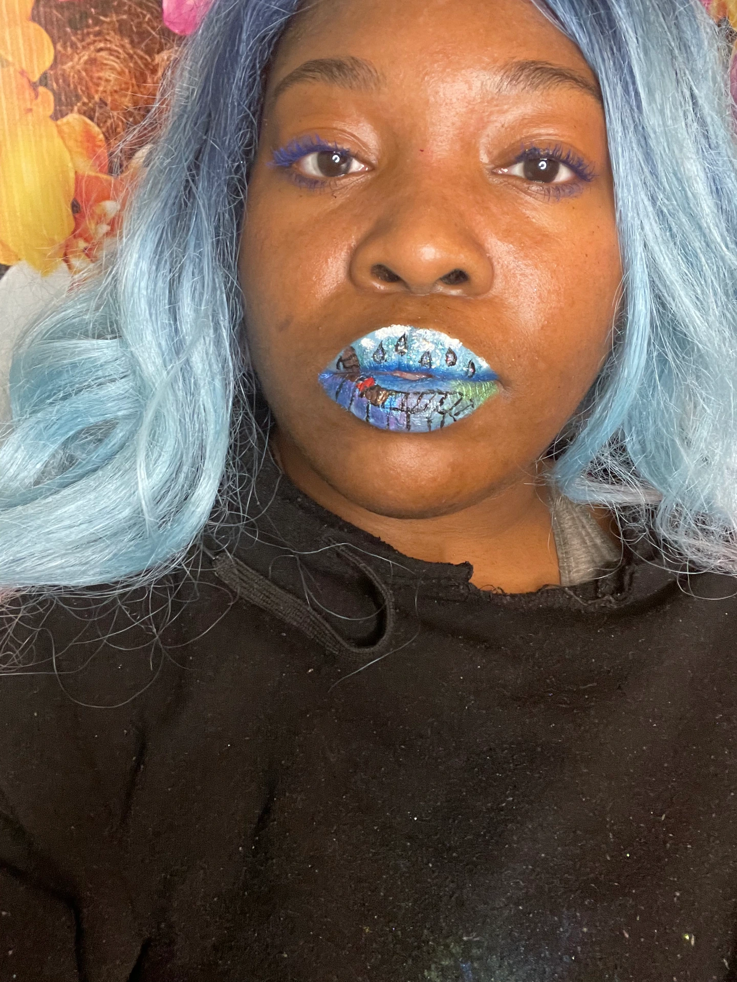 Woman with pale blue curls and bright cobalt metallic lipstick