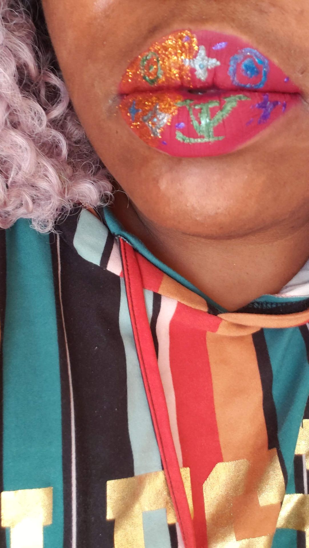 Close-up of multicolor foil lip design with striped scarf
