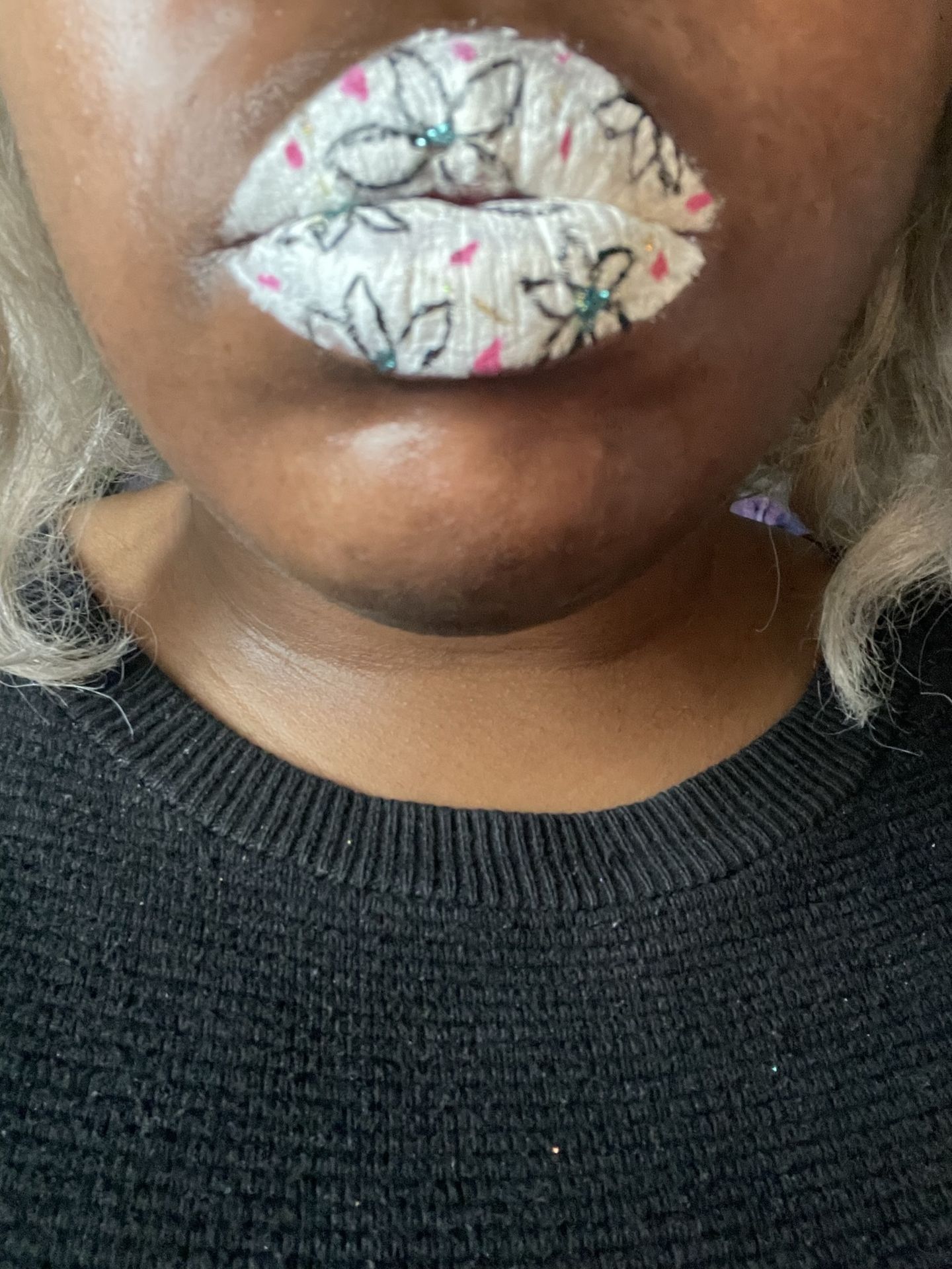 Close-up of pearl-white crystal lipstick on dark skin