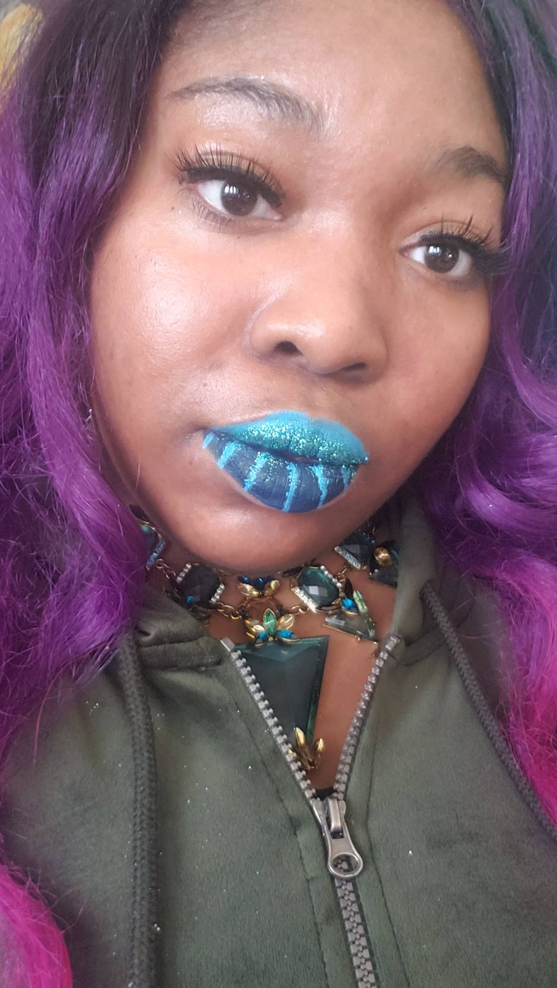 Woman with violet hair wearing electric blue glitter lipstick