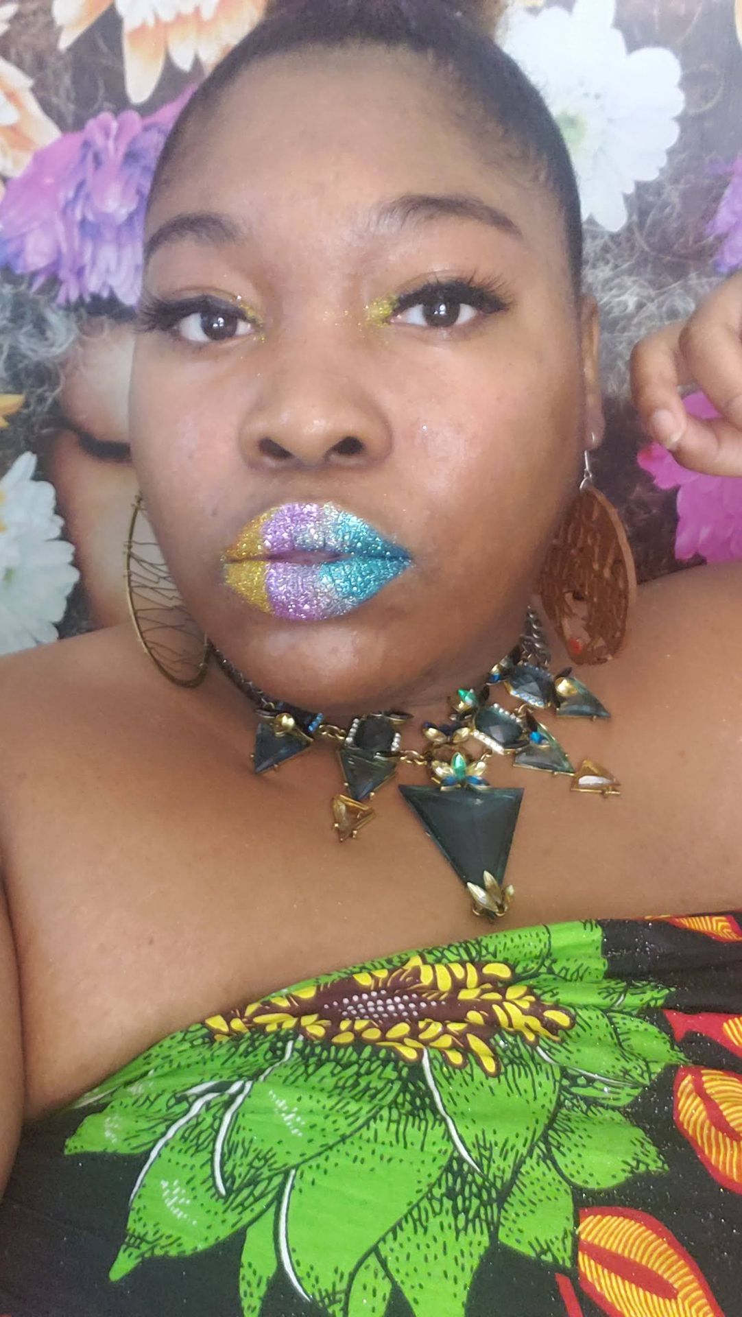 Woman with pale blue hair and lime-green rhinestone lip design