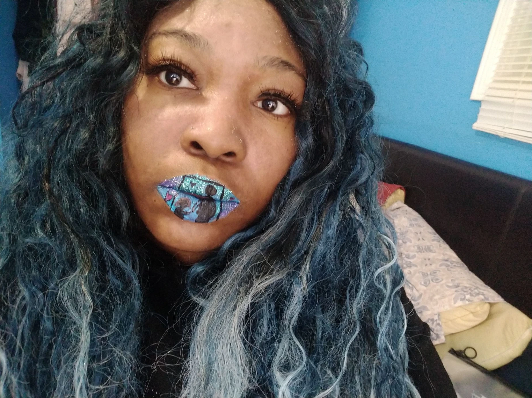 Black woman with icy blue wig and silver shimmer lips, futuristic beauty look in studio lighting.