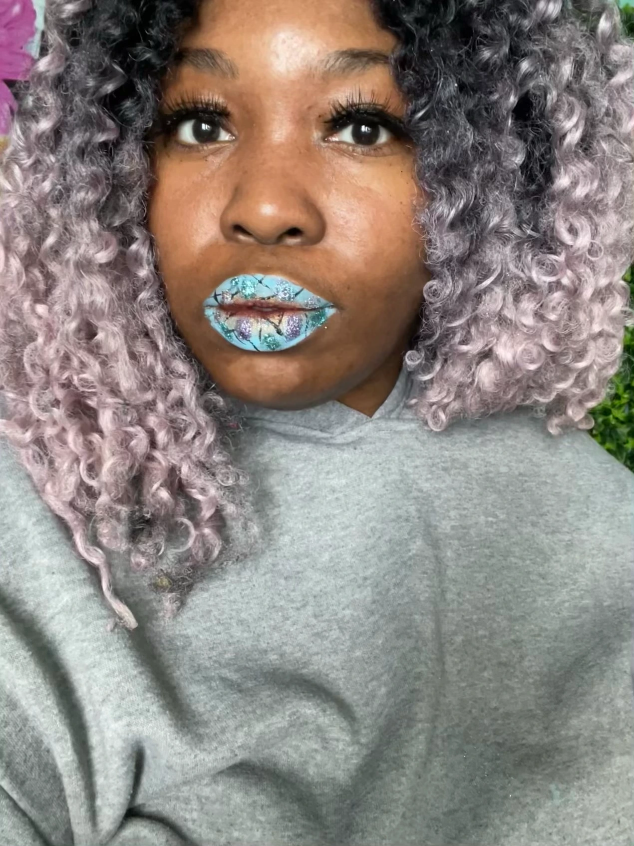 Woman with silver curls wearing icy teal crystal lip design