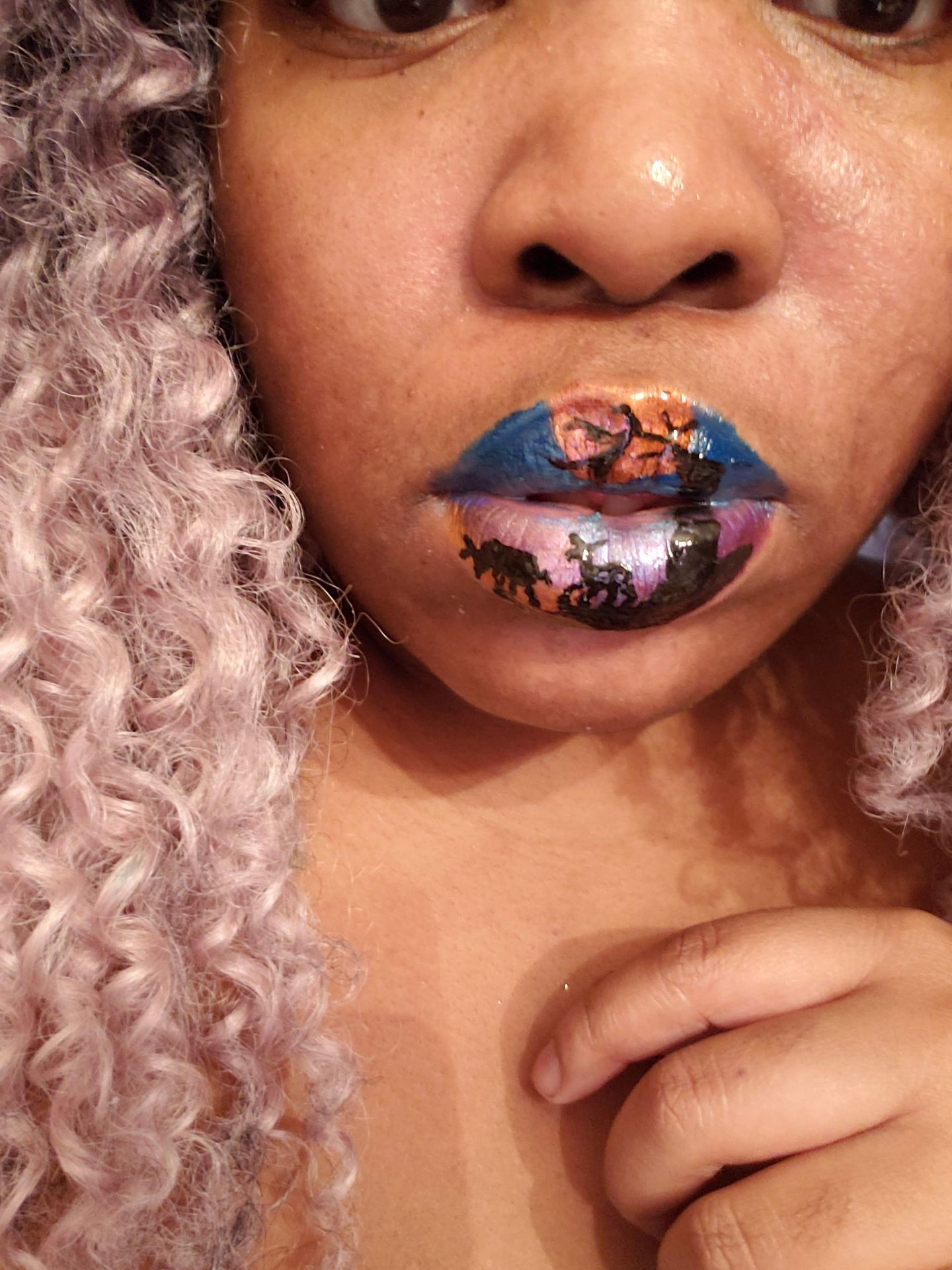 Black woman with lavender curls and blue-purple foil lip art