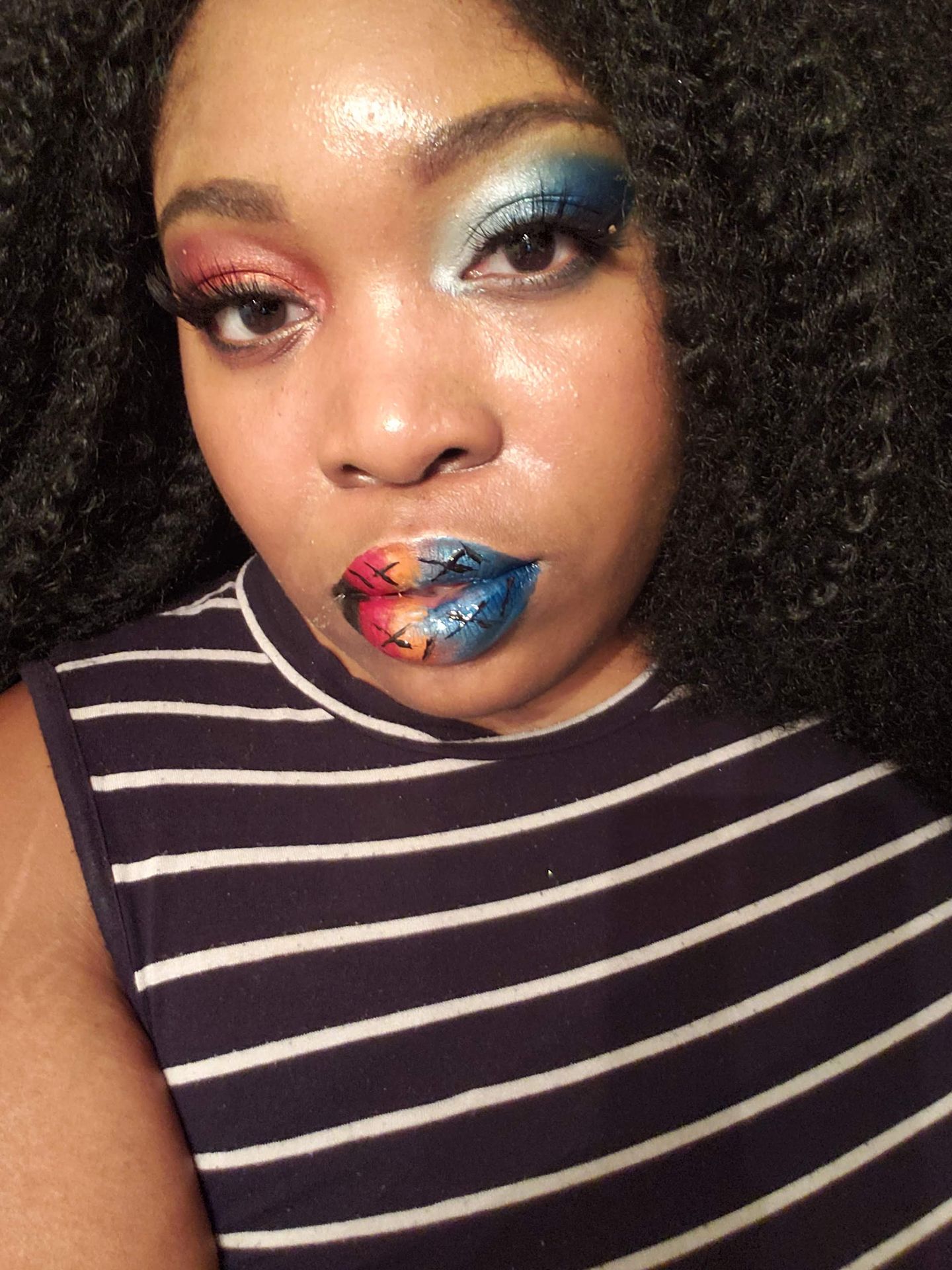 Woman in striped top with teal and silver crystal lip design