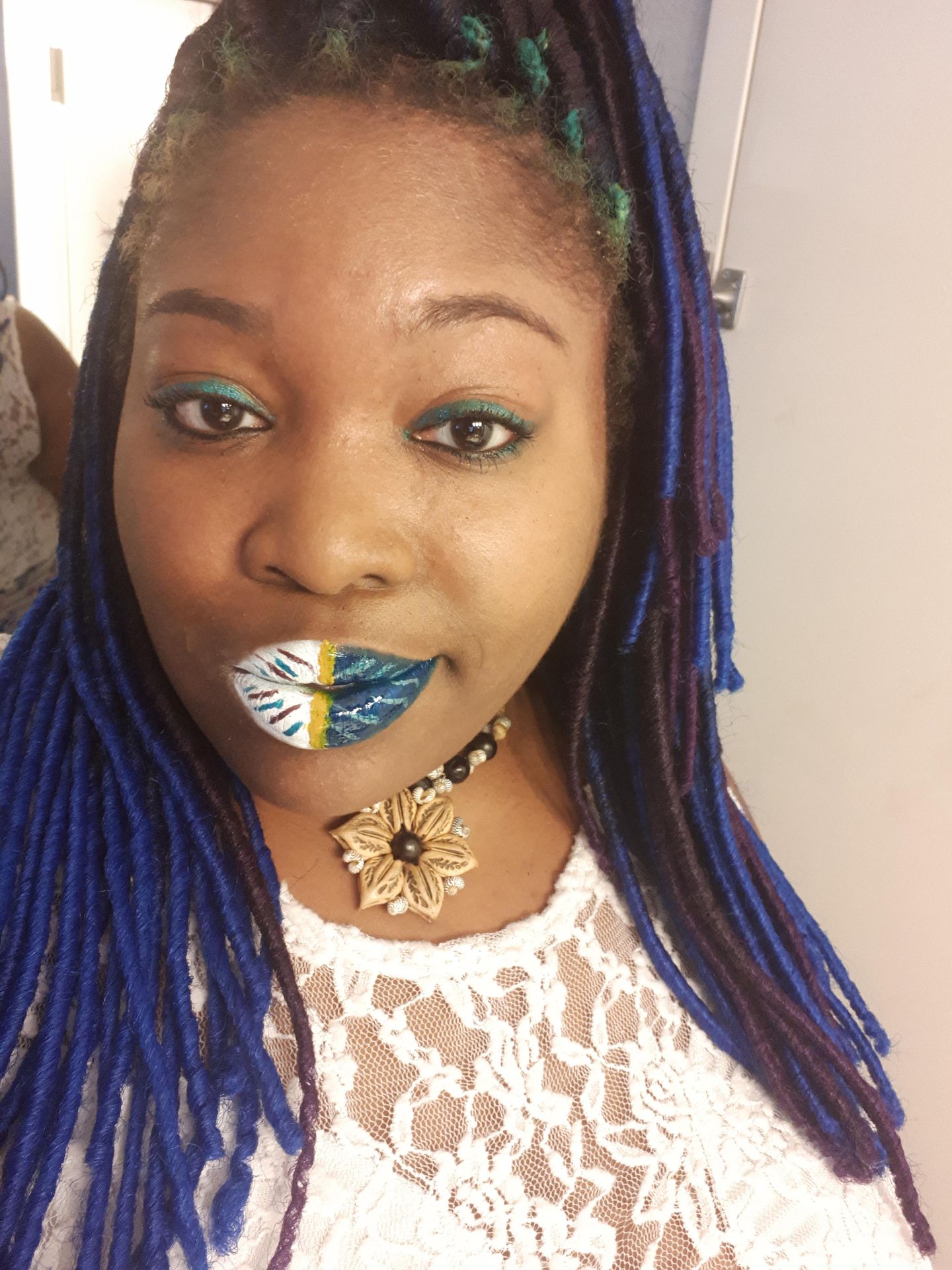 Woman with long braids and emerald green glitter lipstick