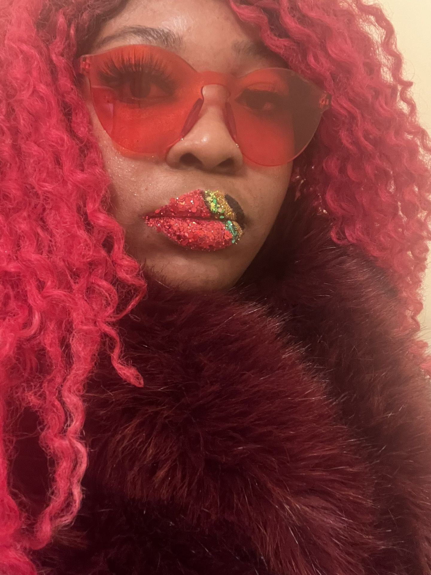 Woman with crimson hair and ruby-red satin lipstick