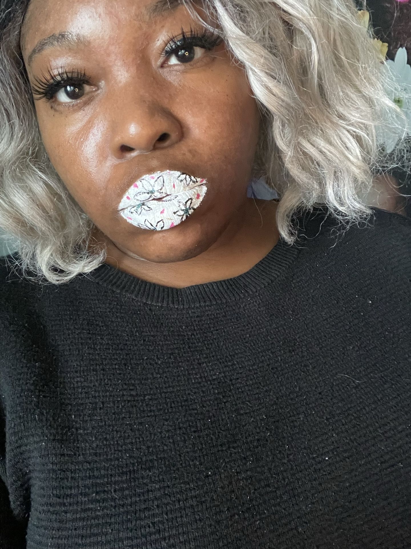 Woman with platinum curls wearing soft pearl-white shimmer lipstick