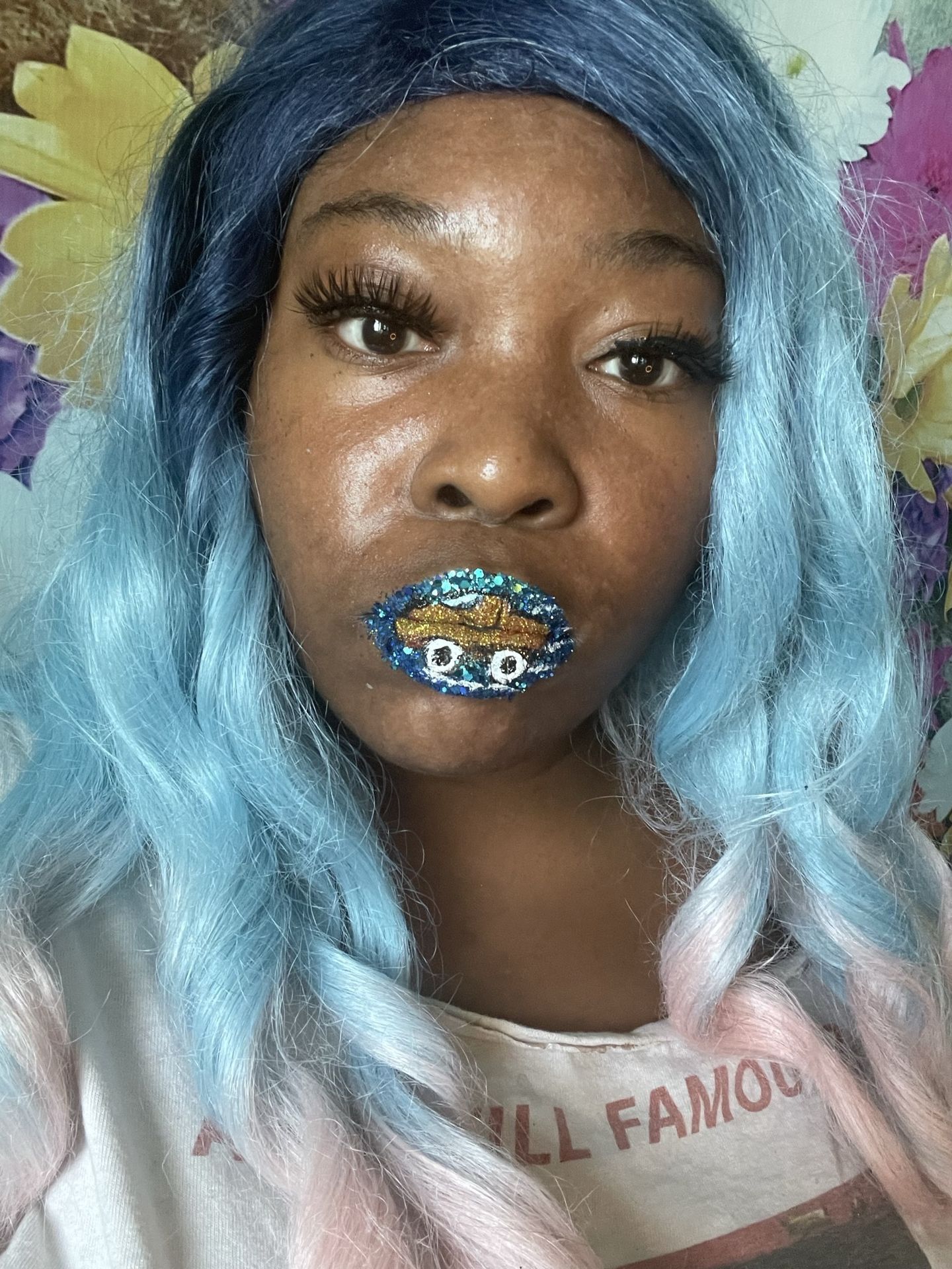 Woman with light blue waves wearing turquoise chrome lipstick