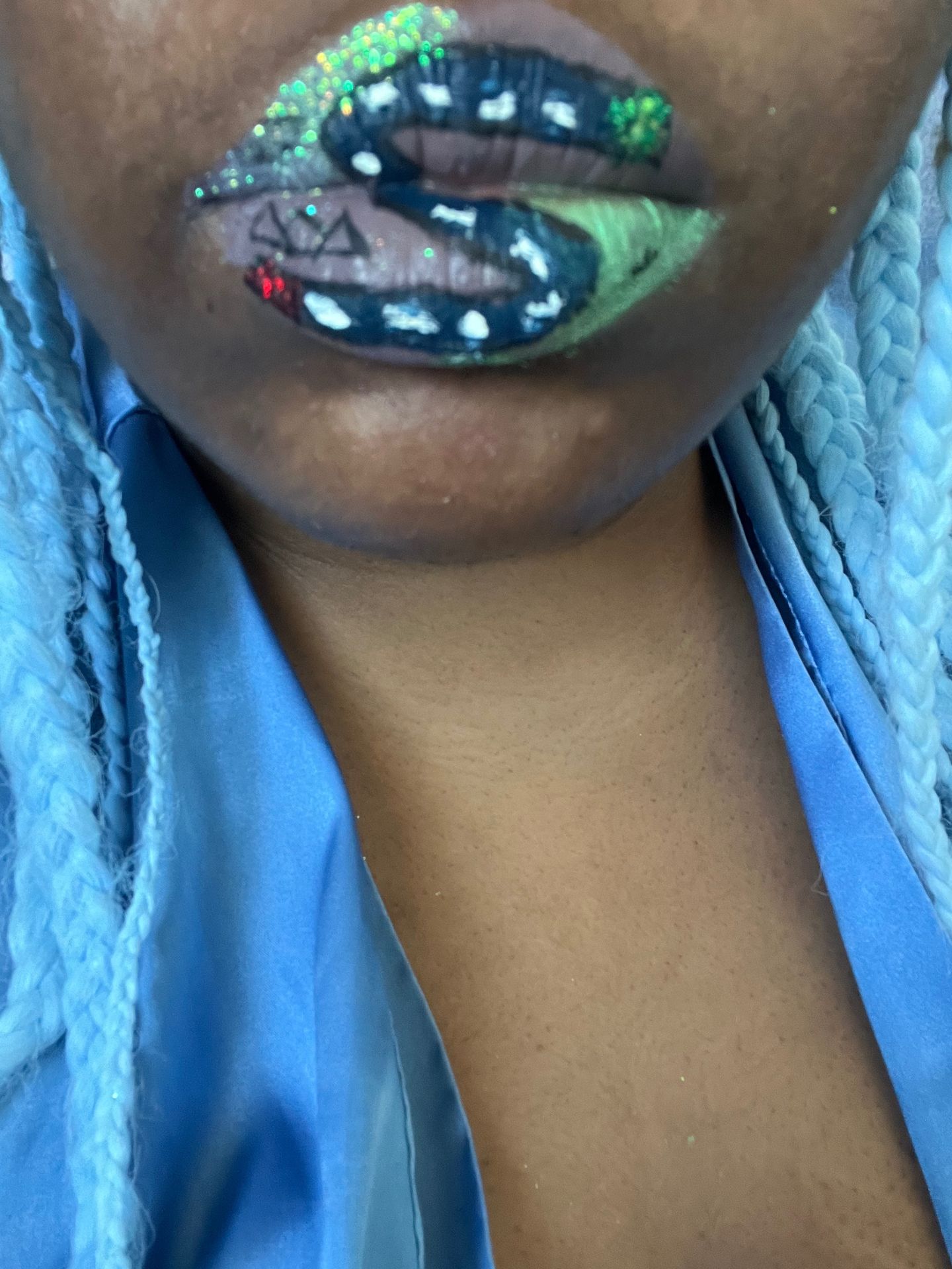 Woman with sky-blue hair wearing deep sapphire crystal lip art