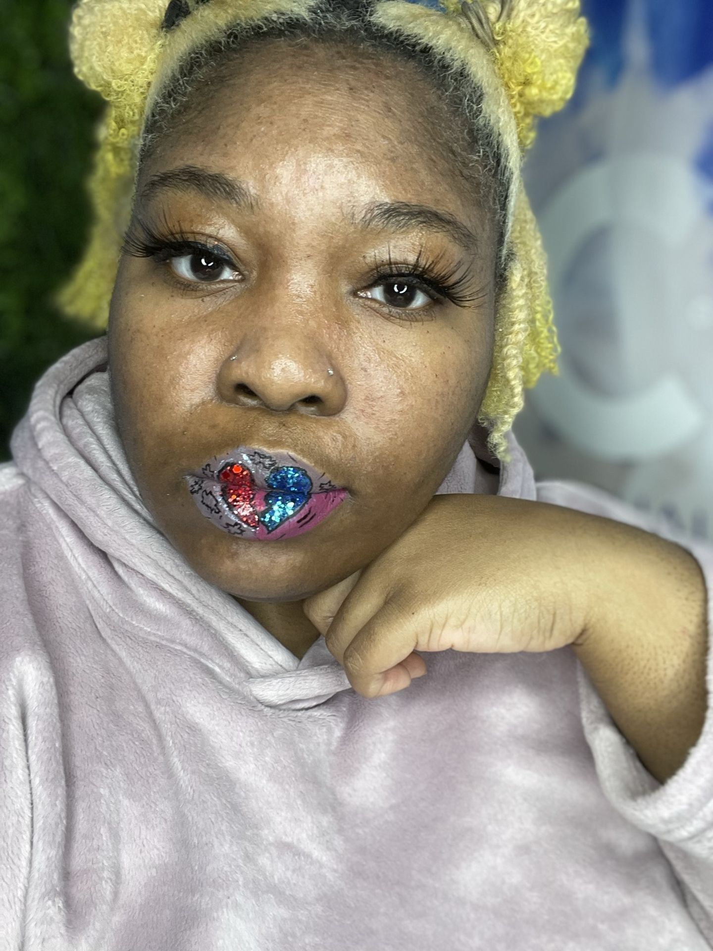 Woman with platinum curls wearing sapphire glitter lipstick