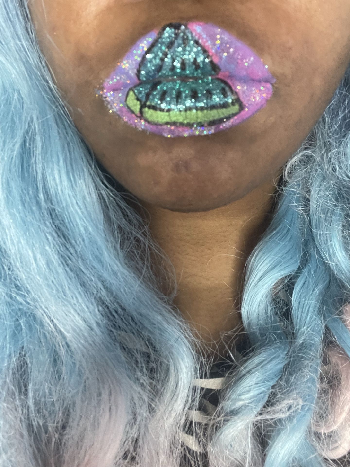 Woman with icy blue hair wearing multicolor glitter mosaic lips