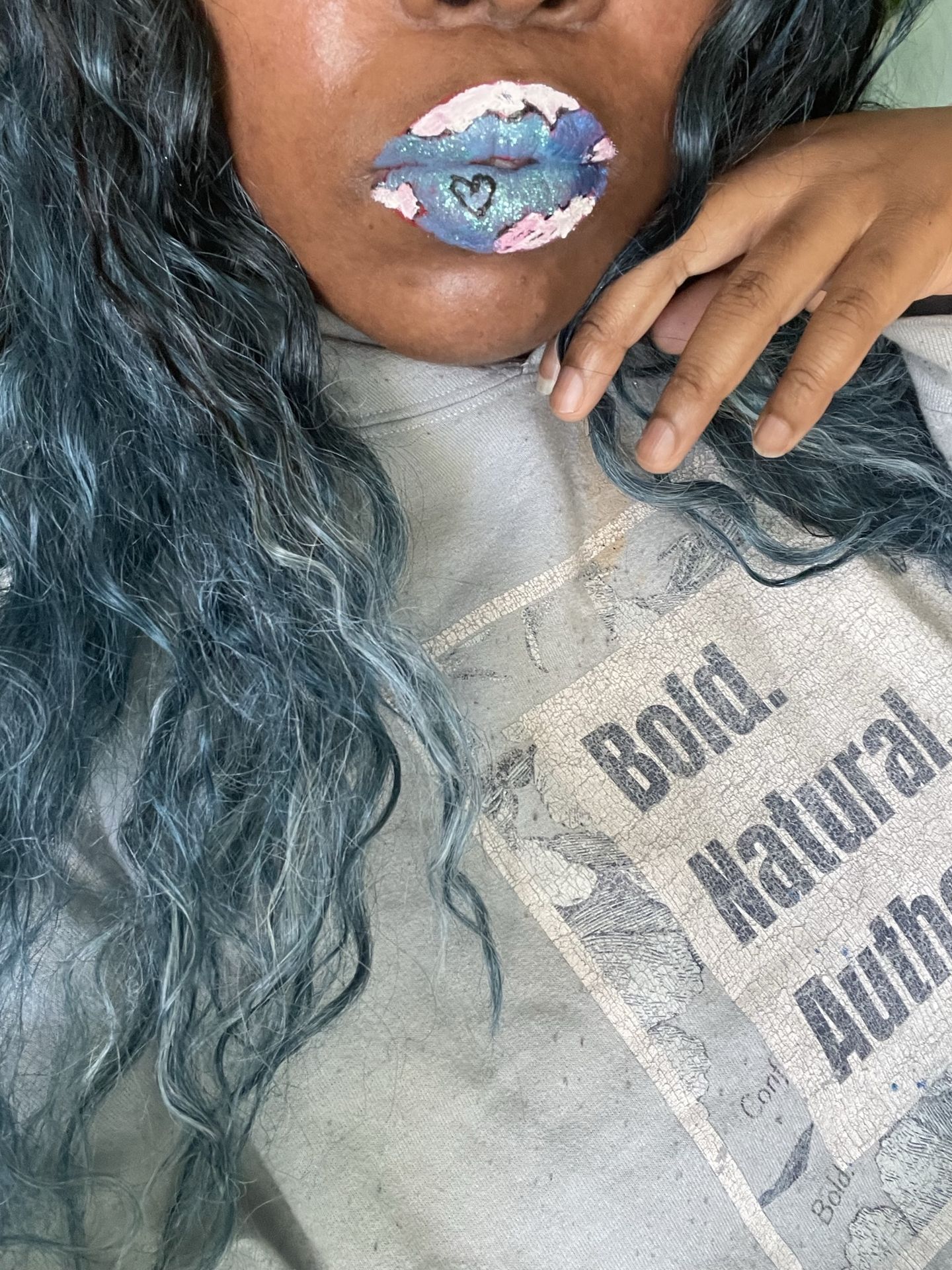 Woman with steel-blue curls and soft pearl-sheen lipstick