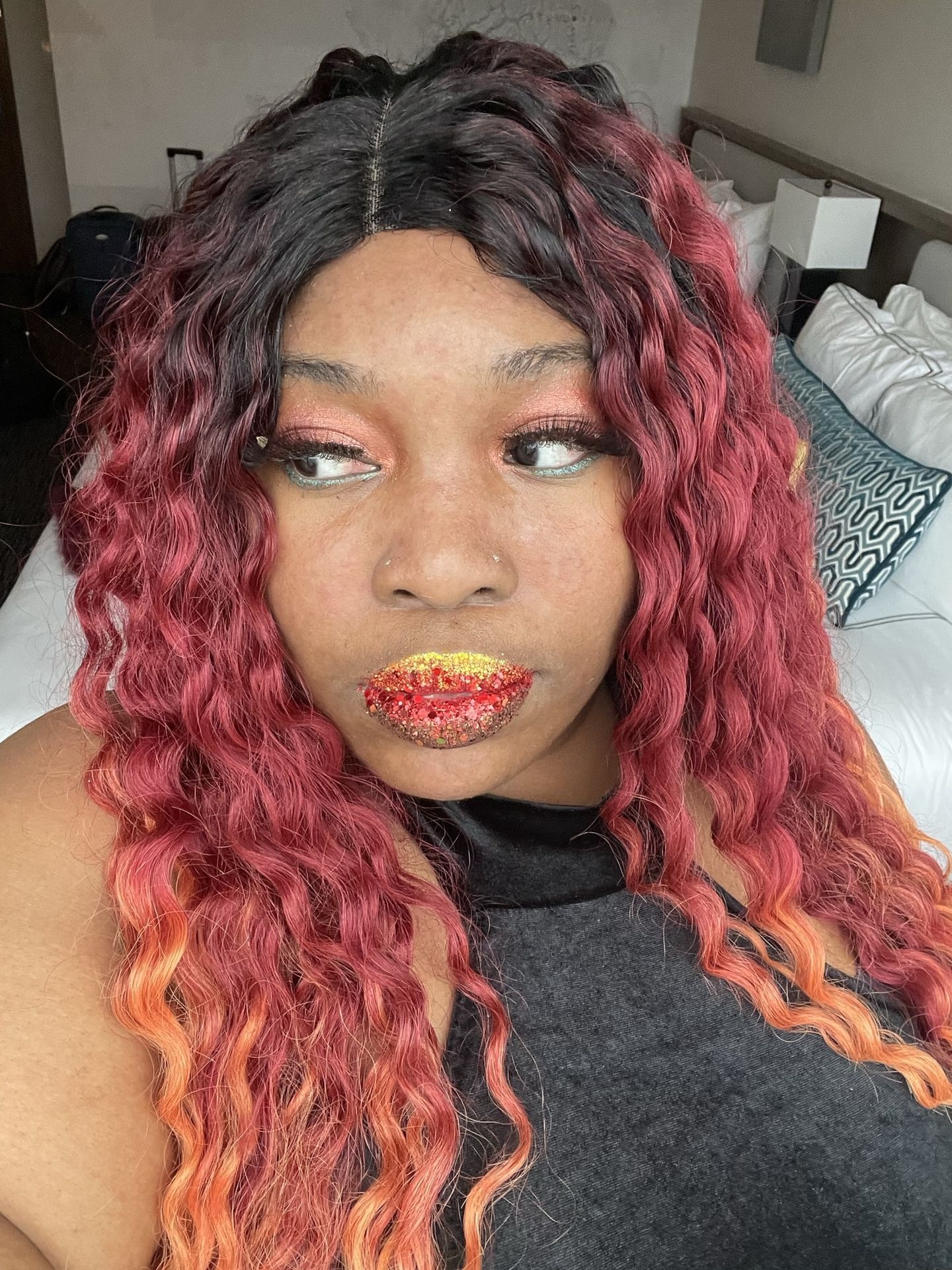 Black woman with purple and blue ombré hair wearing mint green glitter lipstick