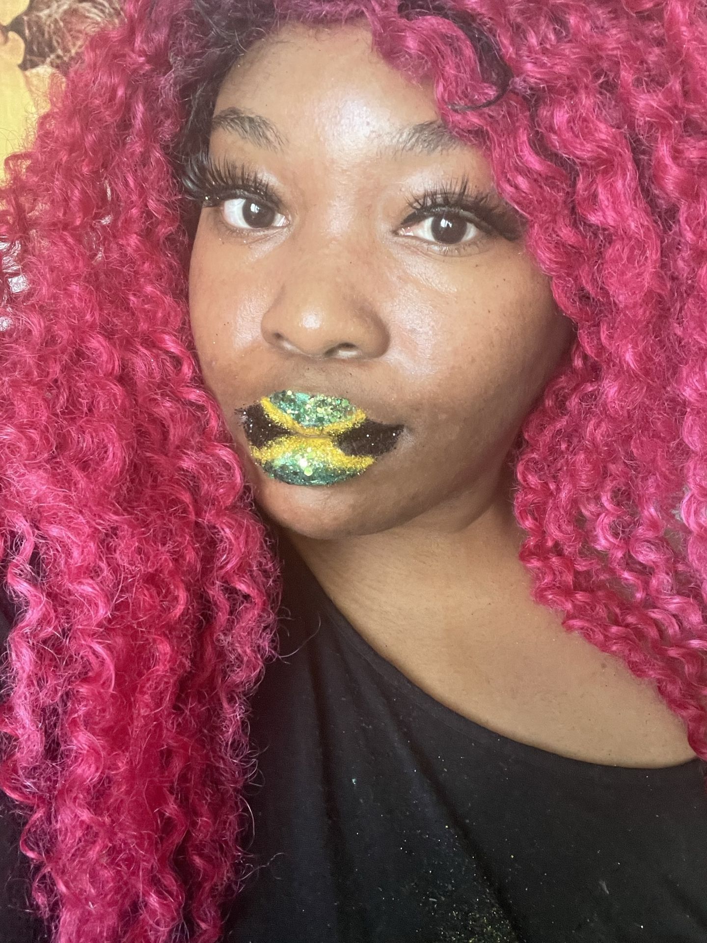Woman with crimson curls wearing gold and green foil lip accents
