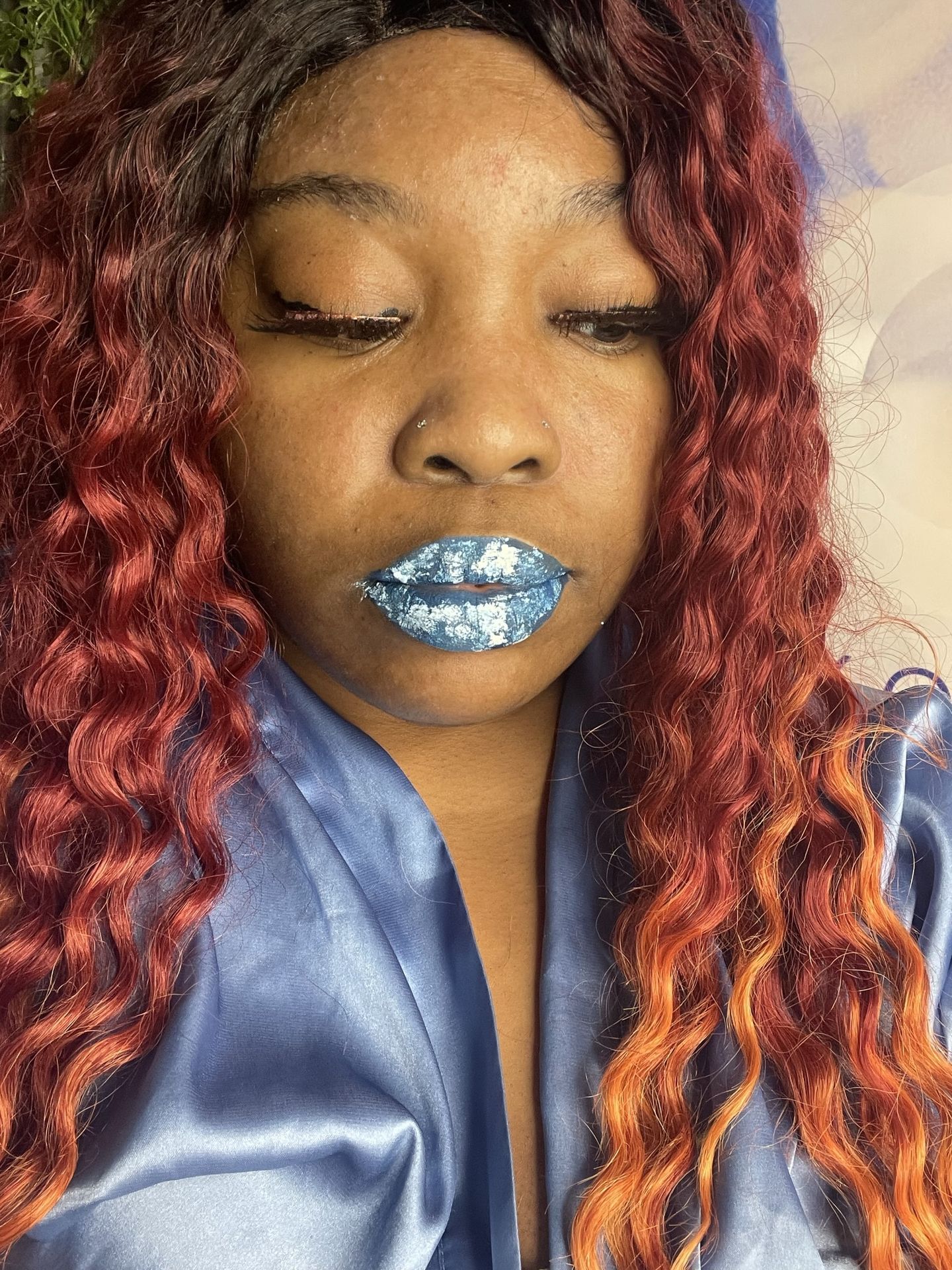 Woman with copper curls and silver-blue glitter lips