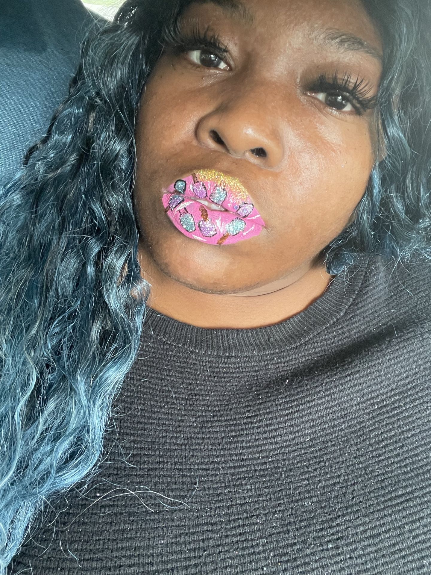 Black woman with turquoise hair and deep blue glitter lips, dramatic close-up showcasing texture.