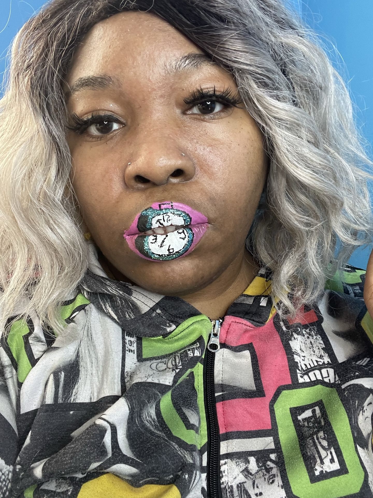 Woman with platinum curls and multicolor gemstone lip mosaic