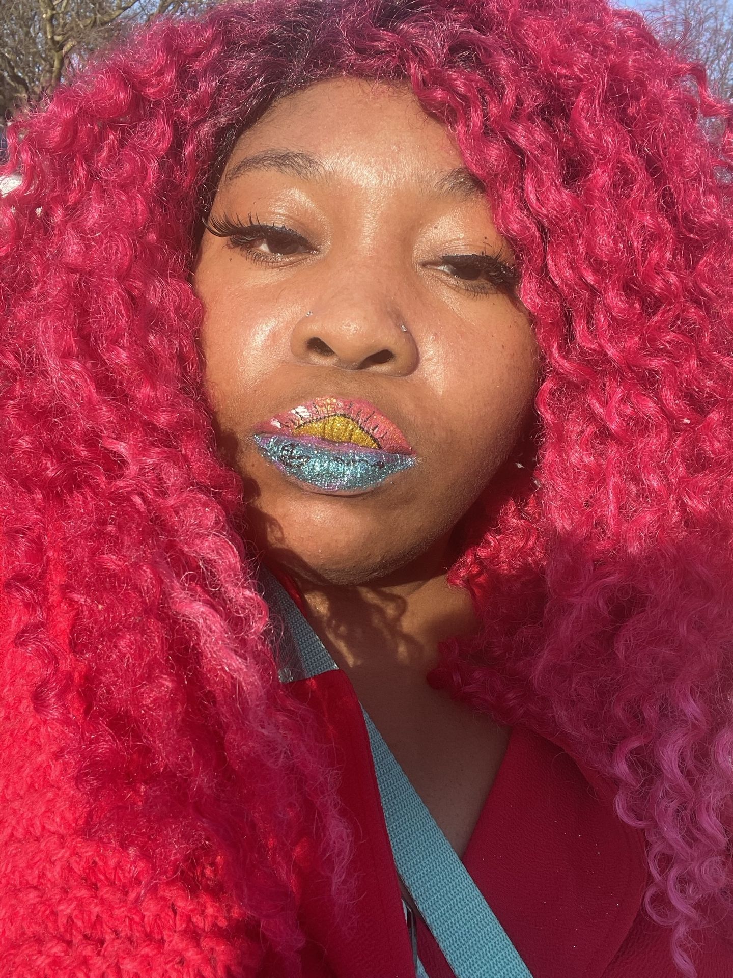 Black woman with pink braids and rhinestone crystal lip design